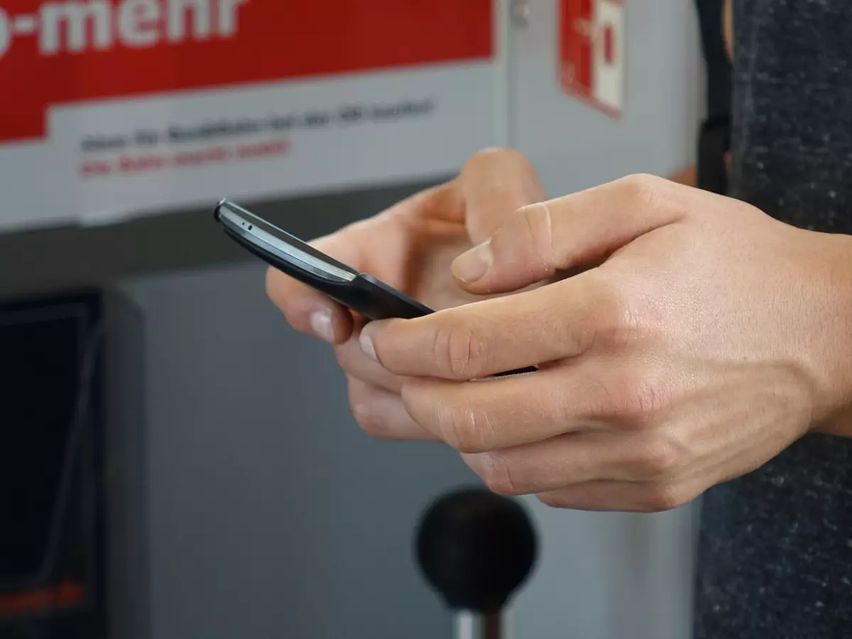 A close-up of a smartphone screen showing the WhatsApp icon among other app icons.